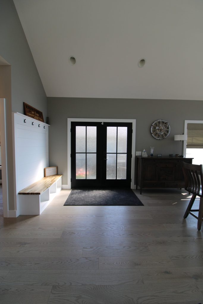 Front entry with glass double doors and a built-in bench at The Lake House