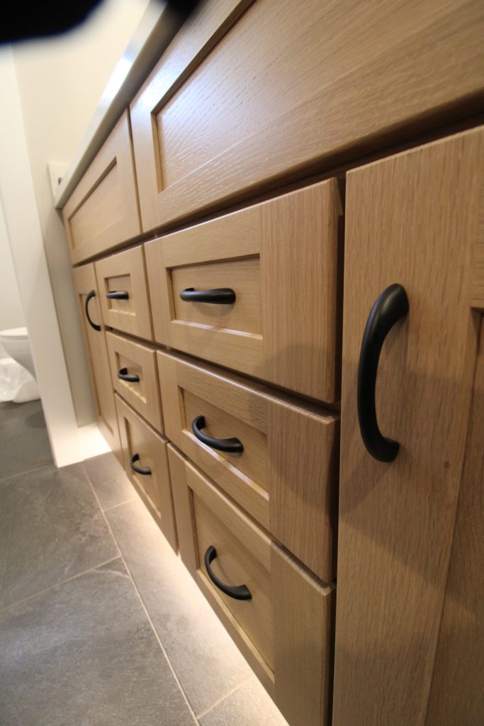 Wood vanity drawers with black hardware at The Lake House