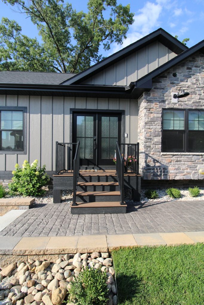 Exterior entry with stone and board and batten siding at The Lake House
