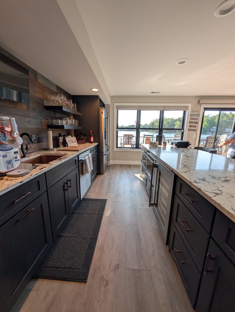 Galley kitchen with dark cabinets and lake views at The Lake House