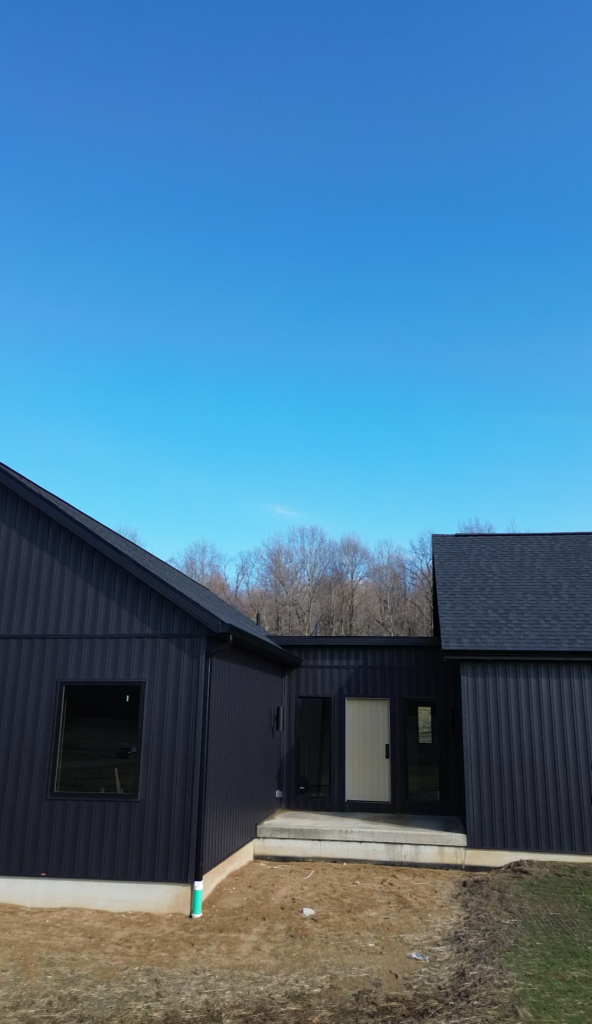 Exterior of The Still House with black siding and a connecting breezeway