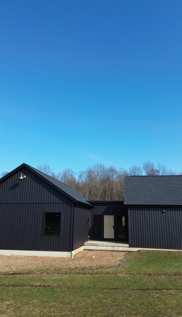 Black-sided exterior and entry of The Still House